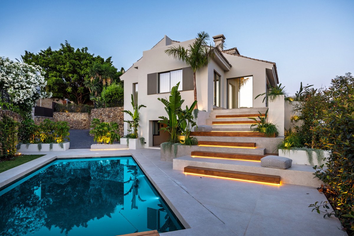 Luxury villa in Spain with private pool and illuminated terrace at sunset
