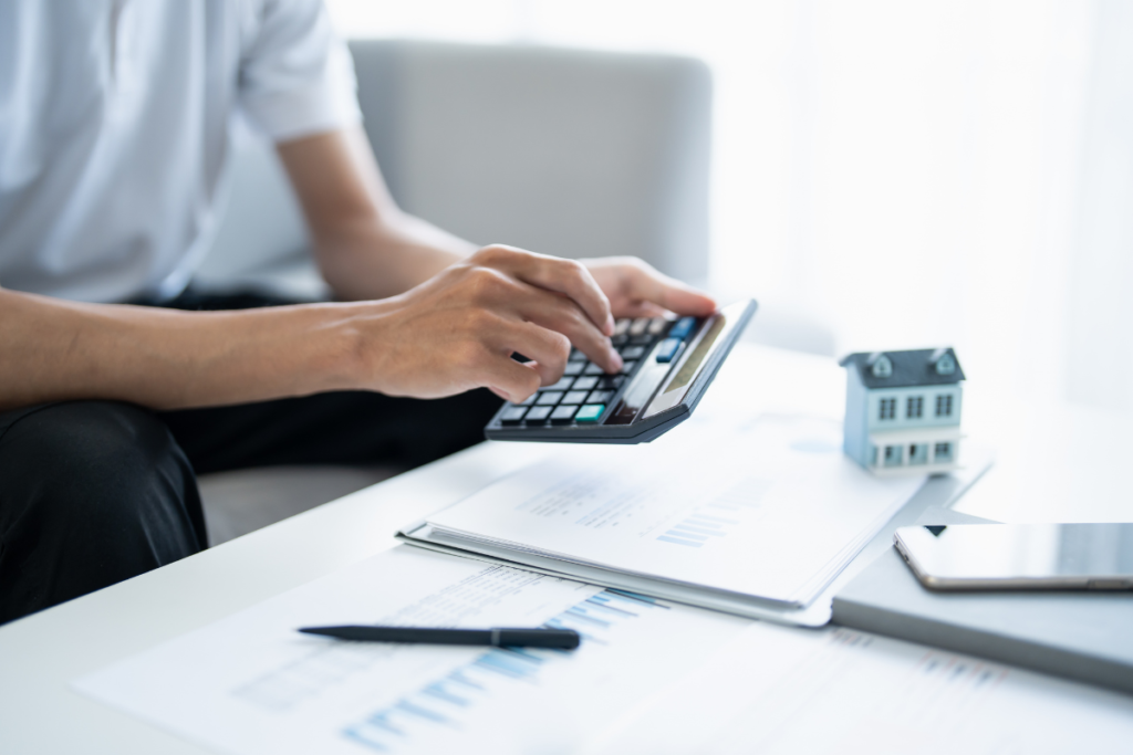 Calculating property investment return with calculator and documents