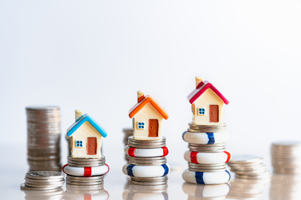 Real estate investment growth with house models on coins