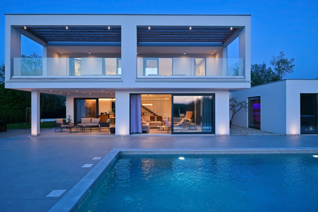 modern luxury villa in Spain with private pool terrace and outdoor lighting at night